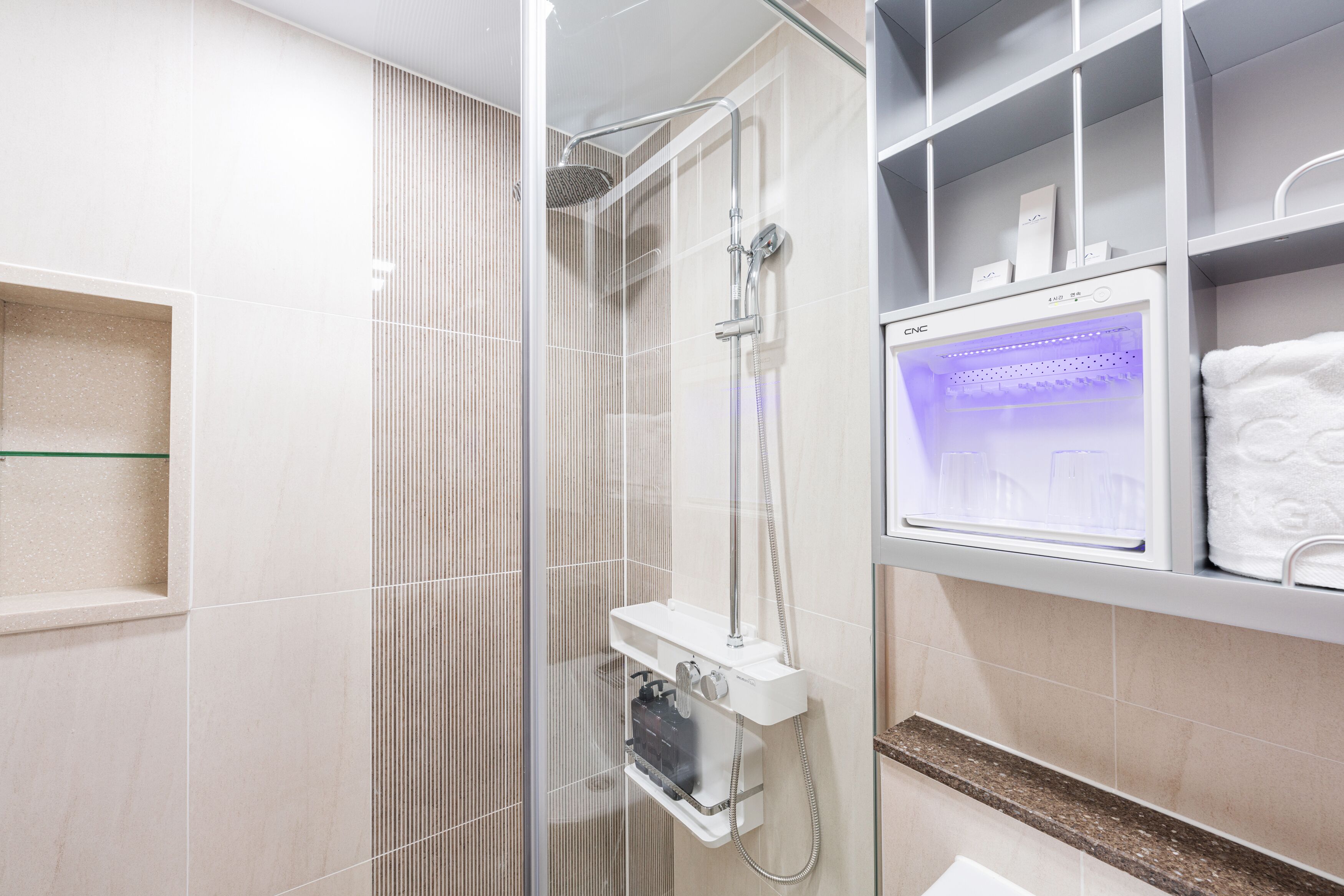 shower, rainfall showerhead, hair dryer, towels