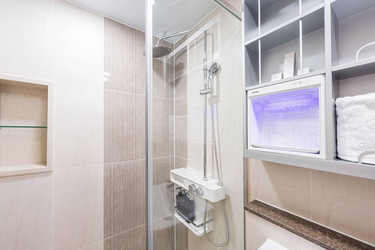 shower, rainfall showerhead, hair dryer, towels