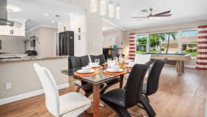 A modern kitchen with a dining area.