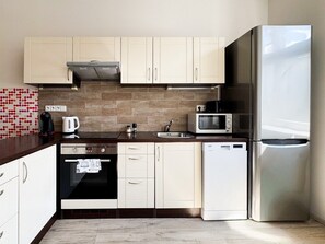 A modern kitchen with stainless steel appliances, a microwave, and a built-in oven.