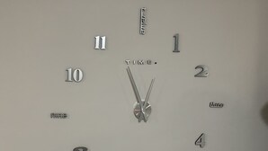 A wall-mounted clock with a minimalist design, featuring numbers and the word "TIME." in the center. - Cozy 3 bedroom house in Ensenada Mexico (Ensenada)