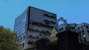 A multi-story building with a modern architectural design, featuring large windows and a flat roof. - Treebo Trend Oxford (Mumbai)