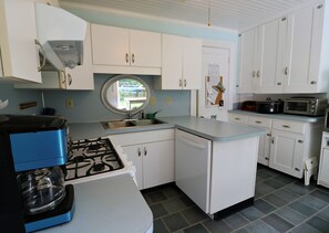 Enjoy cooking in this well-equipped kitchen with a gas stove, microwave, and ample counter space.