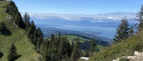 A mountainous landscape with a clear view of a valley and a body of water.