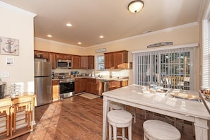 Enjoy cooking in this well-equipped kitchen with a large island and plenty of natural light.