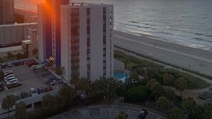 A high-rise hotel with a view of the ocean at sunset. - Beautiful Ocean view corner unit (Myrtle Beach)