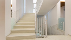 A staircase with white railings and beige steps leading to an upper floor. - 1866 Stella Bianca Luxury Suite (Lecce)