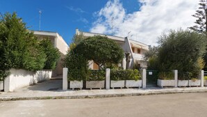 A residential building with a flat roof, a visible antenna, and a gated entrance. - 1892 Casa Di Ronzino (Melendugno)