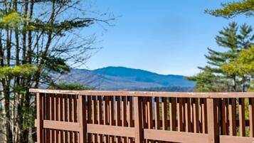 A wooden fence with a view of distant mountains.