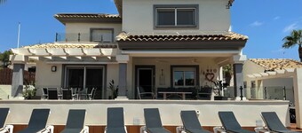 Unwind at this front-line private luxury villa with panoramic golf and sea views