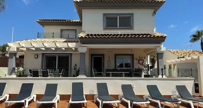 Unwind at this front-line private luxury villa with panoramic golf and sea views