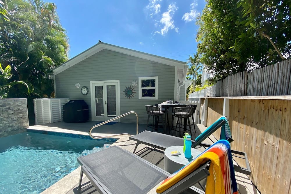 Step into this beautifully restored and redoracated 1933 Key West Home. This first floor home has Bahama shutters throughout the house to open up and let in the Key West sun. Relax in the living with with a large screen TV or sit on the front porch to read a book and relax with the breezes or if needed, the porch fan. The kitchen is perfect to cook your fresh caught fish with enough room to seat four at the counter top.<br>The master has a queen bed with its own ensuite that has a shower with multiple heads for a very luxurious shower. The guest room has two twins(that can be converted to a king)and it\'s own ensuite bathroom. This bathroom does have a shower/bath combination. Both bedrooms have walk in closets.<br>The backyard has its own private pool and can be heated during our Winter months if needed. There is a table for 4 to eat al dente if preferred and two lounge chairs to get your tan on.<br>This home does come with off street parking and a driveway for a medium sized vehicle.<br>Come, enjoy a month in this beautiful Key West Home! Welcome to the Shady Palms - Private Pool - RealKeyWest
