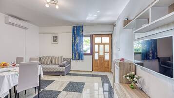 Family Apartment, Multiple Bedrooms, Mountainside (Silver Apartment Sea View) | Living area | 21-inch flat-screen TV with satellite channels, TV, fireplace