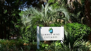 A sign for Summer Wind Cottages surrounded by lush greenery. - 3 BD/2 BA  Pet Friendly Summerwind! Amenity Access included! Close to Beaches, Pools, Dining & Golf! (Seabrook Island)