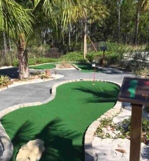 Play a round of golf amidst lush greenery and scenic surroundings.