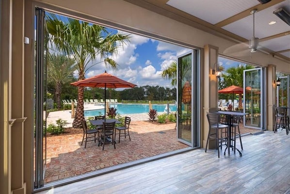 Relax by the pool surrounded by palm trees and enjoy the view from the shaded patio.