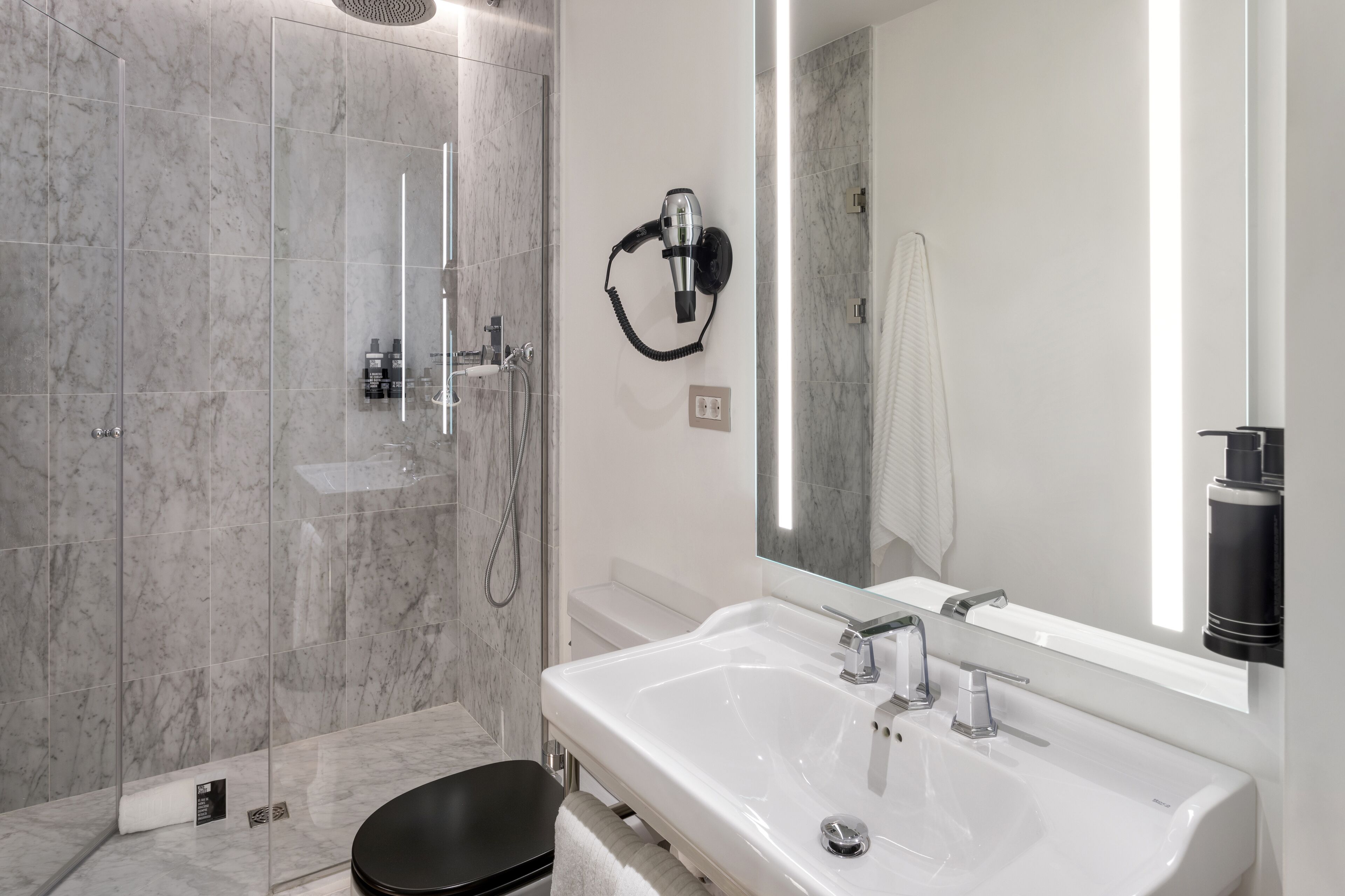 shower, rainfall showerhead, hair dryer, towels