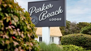 A sign for Parker Beach Lodge with a logo and the name of the lodge. -  Parker Beach Lodge (South Yarmouth)
