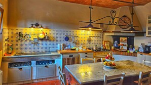 A kitchen with a tiled backsplash, wooden cabinets, a marble countertop, and a hanging light fixture. - MY TUSCANY VILLA: Absolute privacy, between pine and olive trees (Palaia)