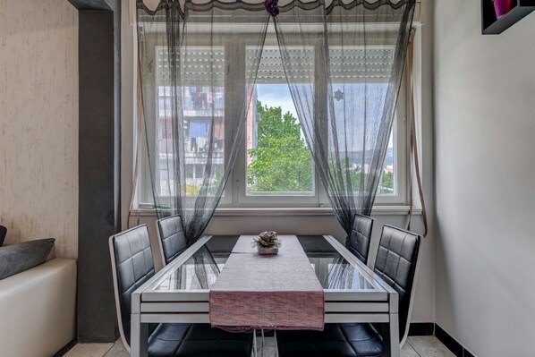 Enjoy meals in this cozy dining area with a glass-top table and four cushioned chairs.