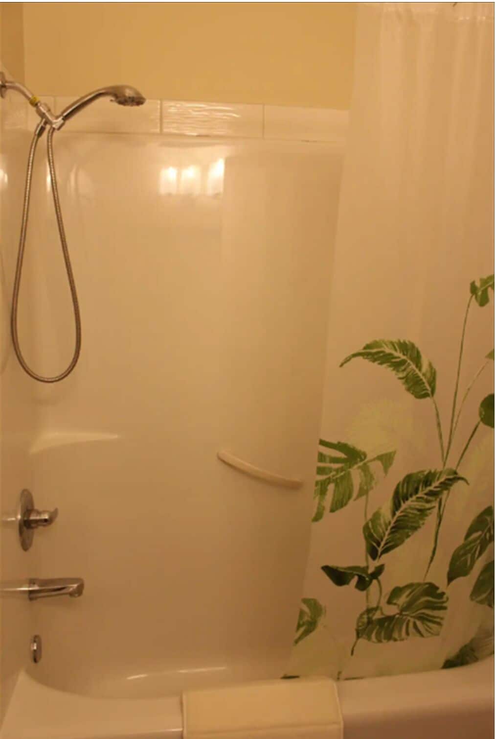 A bathroom with a shower, a toilet, and a sink.