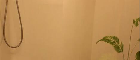 A bathroom with a shower, a toilet, and a sink.