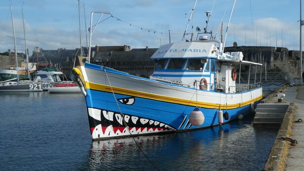 A blue and white fishing boat named 'SANTA-MARIA' docked at a harbor with a stone wall and other boats in the background. - House located in Concarneau in a quiet area close to amenities (Concarneau)