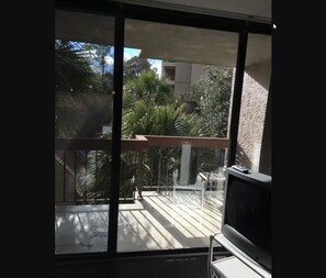 Enjoy the serene views from your balcony, featuring a table and chairs, and a TV for your entertainment.
