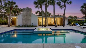 A modern house with a swimming pool, surrounded by palm trees and a sunset sky. - Majestic Coastal Escape (Siesta Key)