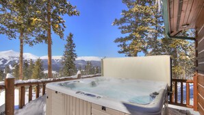 A hot tub on a wooden deck with a snowy mountain view. - Welcome to Lucky Us Cabin! Private + Close to Town (Breckenridge)