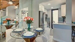A modern kitchen with a stainless steel refrigerator, a microwave, and a coffee machine. - Pass Key Rd Sandy Cove II (Siesta Key)