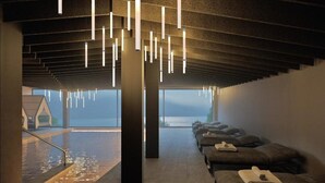 A spa area with a view of the sea, a pool, and a massage room with towels. - Eala - My Lakeside Dream (Limone sul Garda)