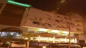 A hotel with a distinctive leaf-patterned facade and a sign reading "GRAND KAUMAS." - ZEN Rooms KH Mas Mansyur (Surabaya)