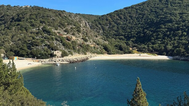 A coastal landscape with a beach, clear blue water, and a forested hill. - Four bedroom villa with private pool with stunning views and beautiful sunsets (Halikeri)