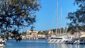 A marina with boats docked, a clear sky, and buildings in the background. - Four bedroom villa with private pool with stunning views and beautiful sunsets (Halikeri)