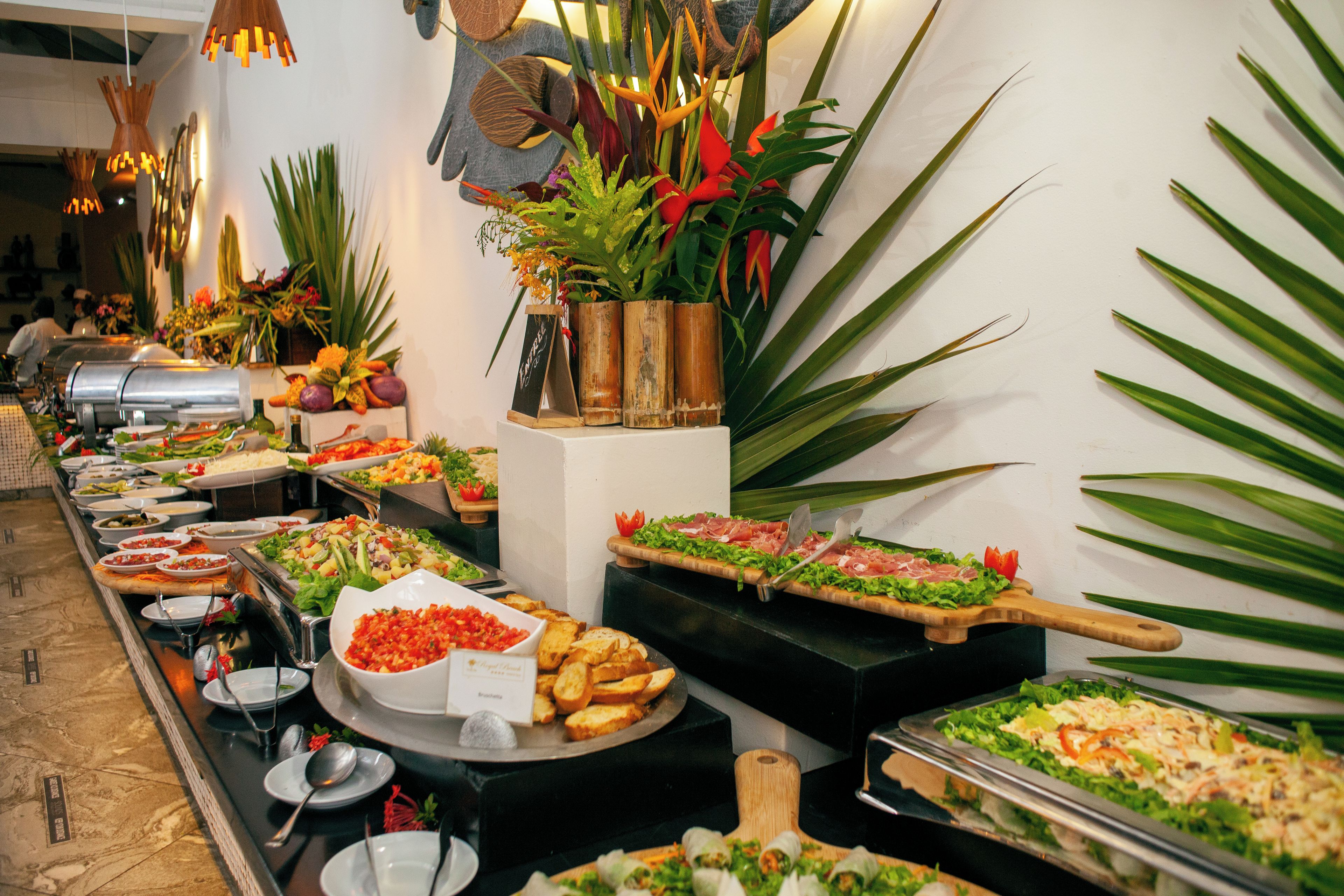 Ein reichhaltiges Buffet mit verschiedenen Speisen und einer dekorativen Pflanzengestaltung.
