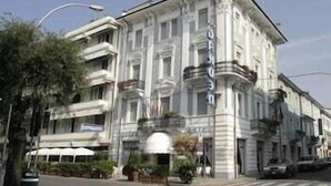 A historic building with classical architecture, featuring a prominent entrance, balconies, and a central dome. - Garden (Viareggio)