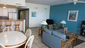 A compact living space with a kitchen, dining area, and seating area. - Grace Bay Prime Location 2 Bedroom Condo with Beach, Pool and Tennis access!! (Grace Bay)