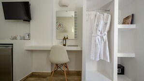 Un baño moderno con lavamanos, espejo y toallero.