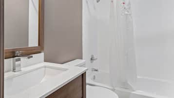 A bathroom with a white sink, a toilet, and a bathtub.