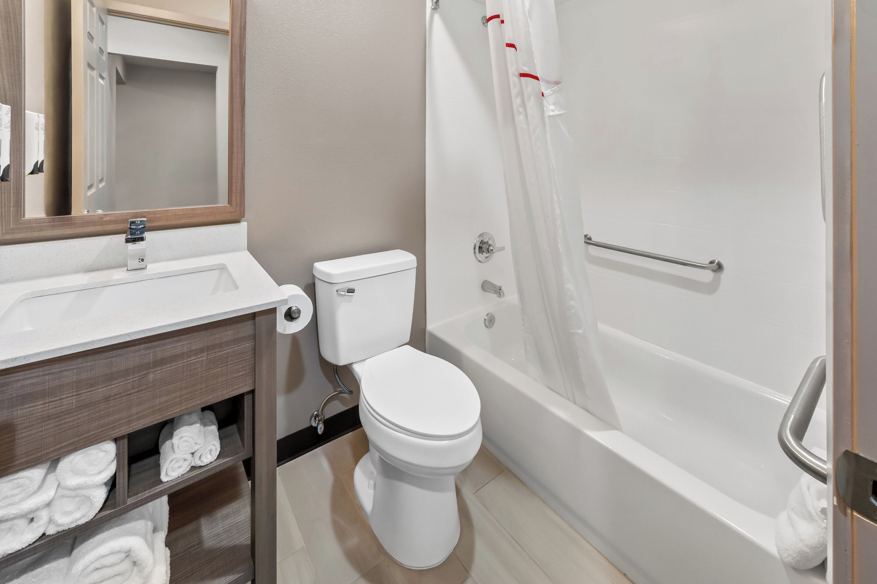 A bathroom with a toilet, sink, and bathtub.