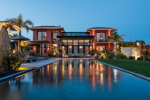 A modern house with a swimming pool, outdoor seating, and a well-maintained garden. - Villa With Heated Pool Sea View (Nice)