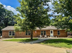 A wooden cabin with a front porch, two windows, and a door. - Secluded Black Bear Lodge w/ Private Pool & Hot Tub near Hocking Hills Ohio (Nelsonville)