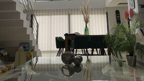 A modern interior with a glass coffee table, a chandelier, a staircase, and a dining area. - Luxury loft with pool and garden (Avignon)
