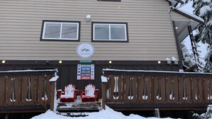 A building with a sign indicating 'The Birdhouse' and directional signs for 'Winter Wren', 'Dicky Bird', 'Chicka-Dee', 'Jacky Winter', and 'Apres Ski'. - Dicky Bird Mount Washington Village (courtenay)