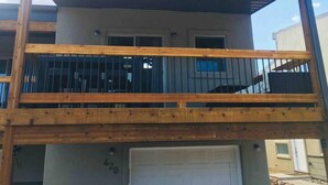 A two-story building with a wooden balcony and a garage door marked with the number 420. - The Aspen - in WPCO at 8488 ft elevation (Woodland Park)