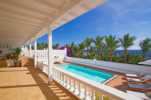 A heated pool, pool loungers