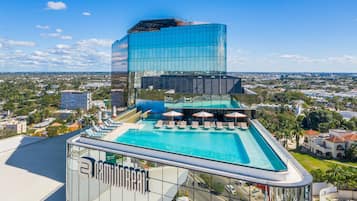 Enjoy panoramic city views from our rooftop pool and sun loungers.
