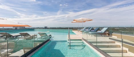 Outdoor pool, open 8:00 AM to 8:00 PM, pool loungers