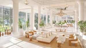 A spacious lobby with high ceilings, large windows, and a variety of seating arrangements. - Centara Reserve Samui (Koh Samui)